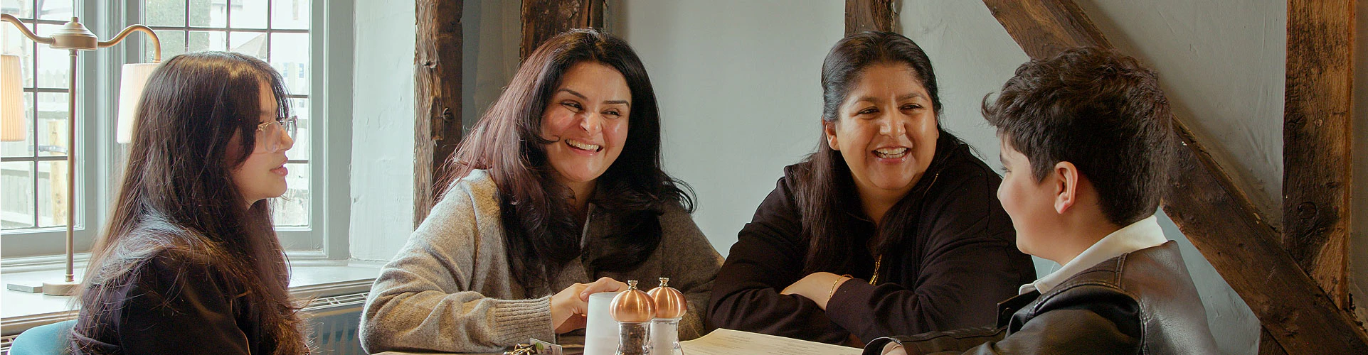 CI user Nandini enjoys a mealtime conversation with her family.