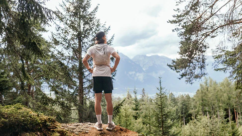 Man hiking in the woods enjoying a moment of silence